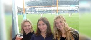 3 female students at a rugby field 