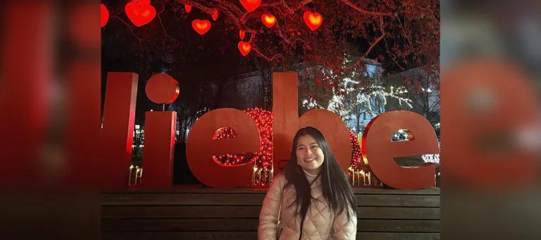 A female standing amongst bright red lanterns 